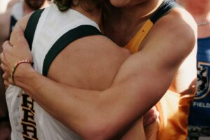 Two athletes embracing after a competition.